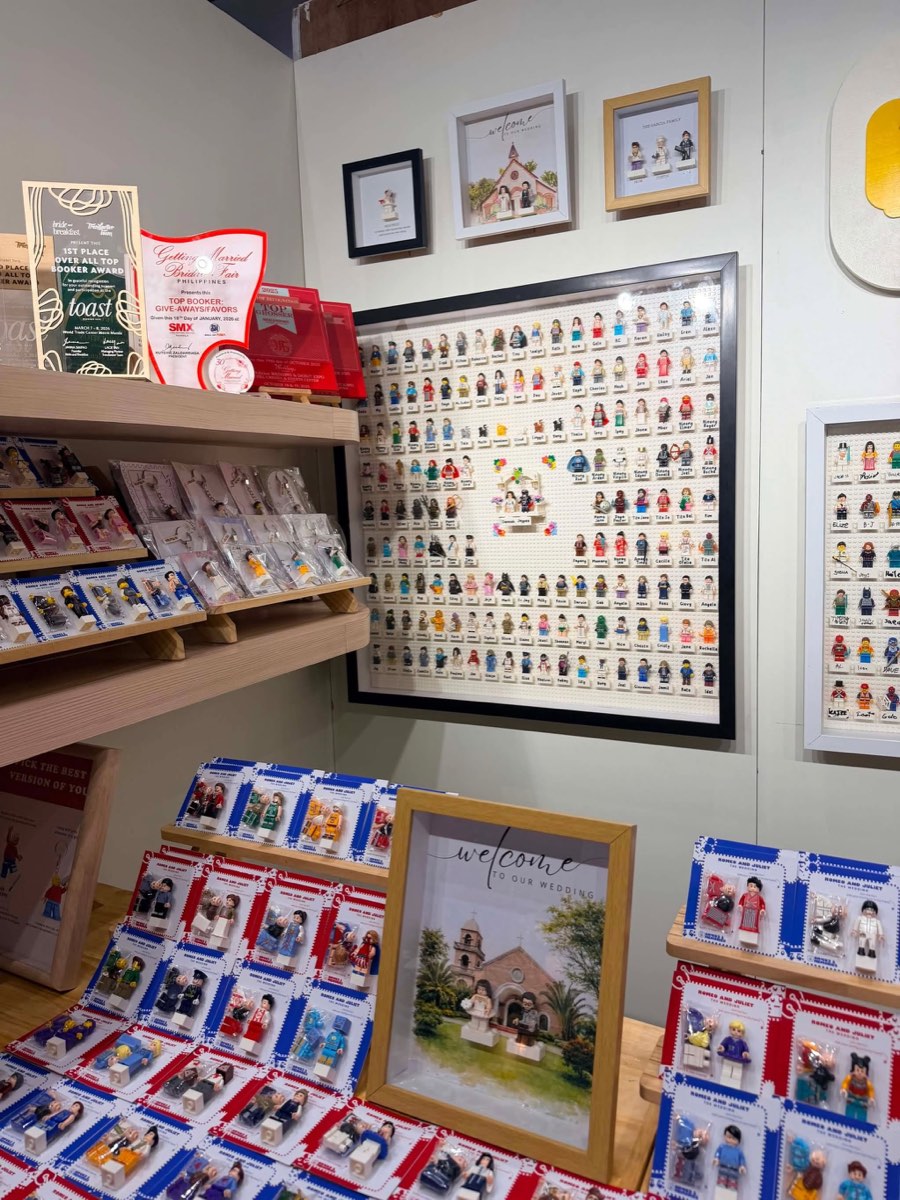 Wall display racks of finished Bricks and Memories frames and keychains at the shop